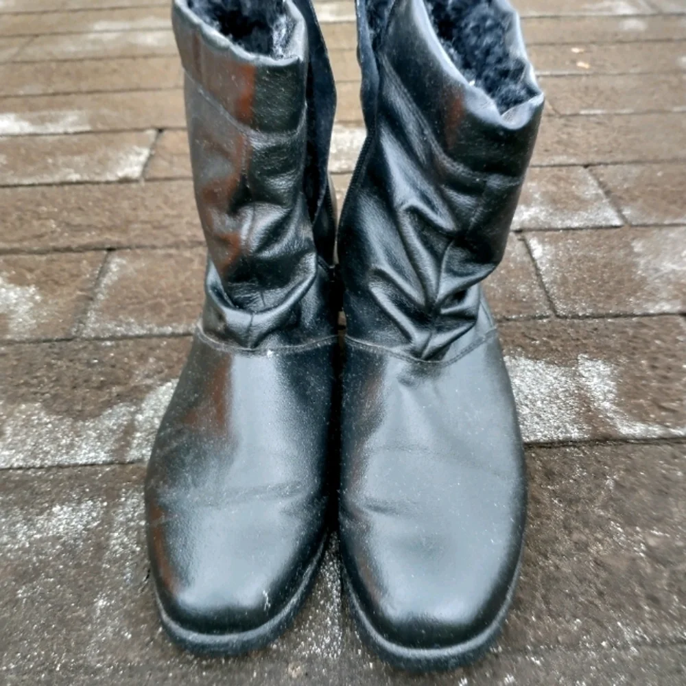 Women's black fleece lined vinyl zipper boots.
